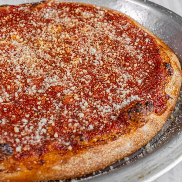 Corbos Pasta and Pizza House's cheese pizza with a thick red sauce and golden crust.